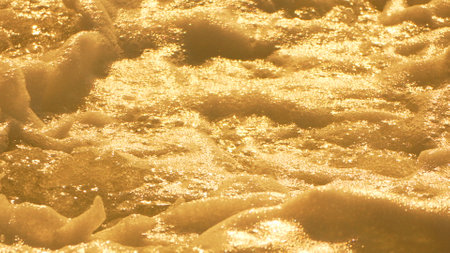 Cave Wall Texture Gold Rock - A close-up of a gold-colored cave wall with a textured surface.の写真素材