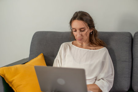 Woman Laptop Home Office: Working remotely on laptop indoors, contemporary lifestyle.