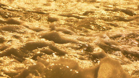 Cave Wall Texture Gold Rock - A close-up of a gold-colored cave wall with a textured surface.の写真素材