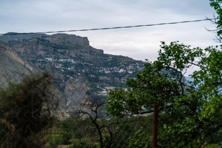 A mountain range with a city in the distanceの写真素材
