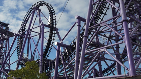 Rollercoaster, amusement park: Thrilling ride structure, summer dayの写真素材