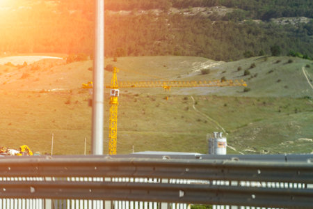 Aerial View, Sunset: High-angle daytime shot showing construction progress in hilly landscape.の写真素材