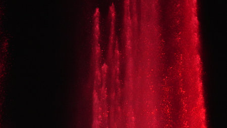 Fountain Water Red Light Night Show: Illuminated water jets display vibrant red light at night, creating an enchanting spectacle.の写真素材