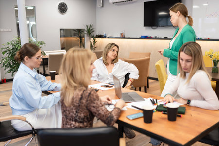 Businesswomen Meeting Office Discussion Collaboration Teamwork in bright office during daytime, for brainstorming.の写真素材