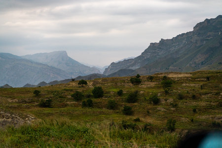 A mountain range with a cloudy sky in the backgroundの写真素材