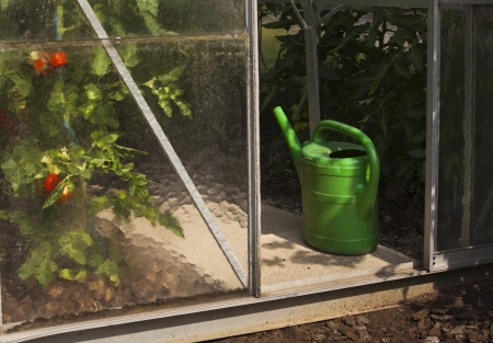 greenhouse with watering can - greenhouse with watering canの写真素材