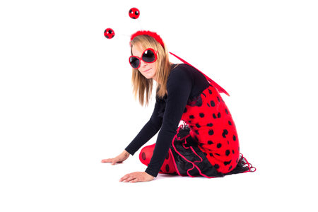 Lady in bug costume sits on groundの写真素材