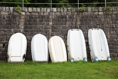 rowing boats leaning against a wallの写真素材
