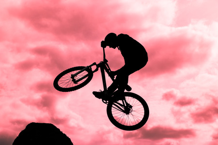 siluette of a biker jumpingの写真素材