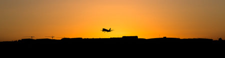 lift off at sunset on a airportの写真素材