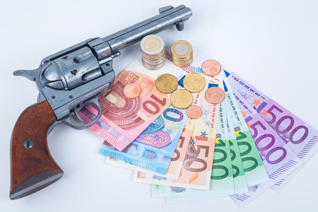 revolver and euro money in coins and notesの写真素材
