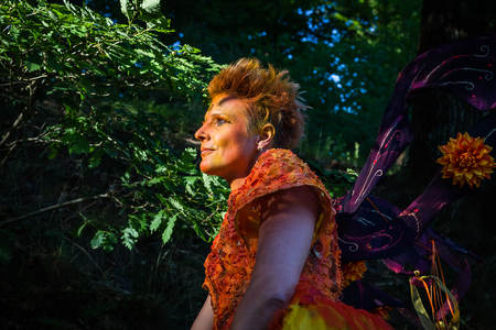 portrait of a woman in orange dressの写真素材