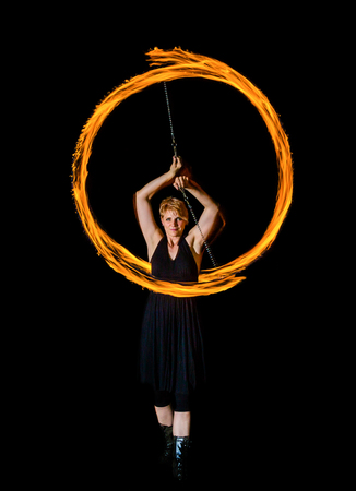 woman creates fire flares with torchesの写真素材