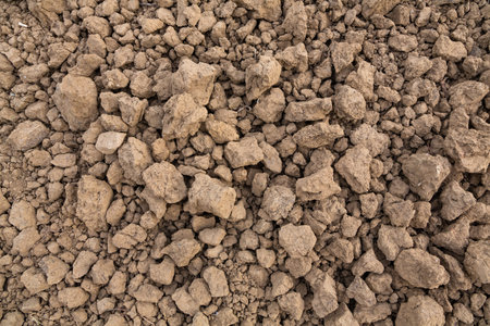 detail of a plowed field with brown pebble soil
