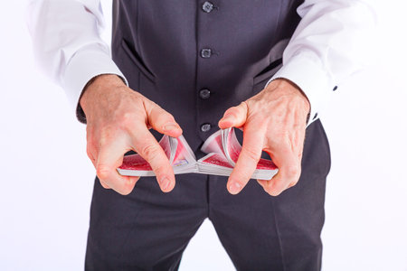 hands are mixing a deck of cards in close upの写真素材