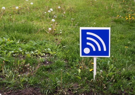 RSS sign on a green lawn. Free wifi simbolの写真素材