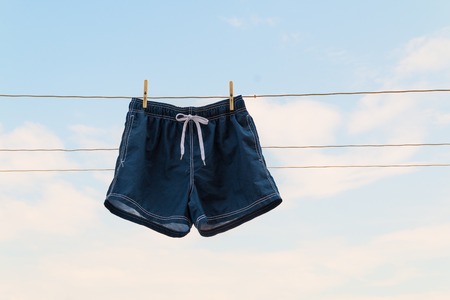 shorts hanging on the clothesline on sky backgroundの写真素材
