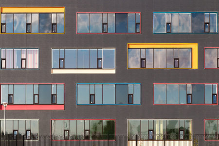 colored windows of the building. geometric background. building's facade.