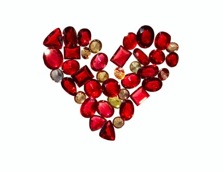 Colored gems make a romantic love heart. Isolated on white. No sharpening has been applied.の写真素材