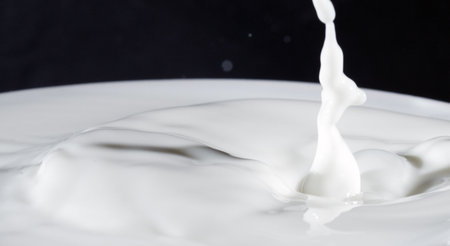 Milk splash on black background.の写真素材