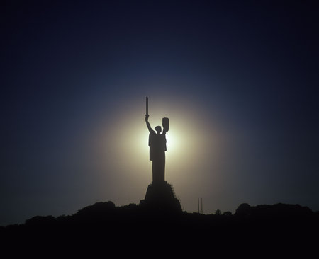 Monument to Motherland with a sunset in the background. Kyiv, Ukraine.