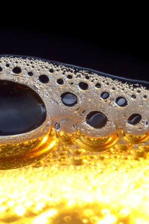 Macro shot of light beer with froth.の写真素材