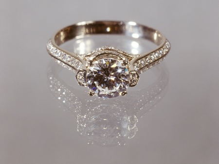 Beautiful gold diamond ring on gray background.の写真素材