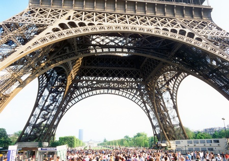 Paris, France - April 24, 2011: A crowd of pedestrians walks near the Eiffel Tower on a sunny day.のeditorial素材