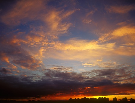 Landscape of houses silhouetted against a sunset.の写真素材