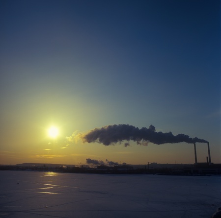 Winter landscape at sunset with two factory chimneys.の写真素材