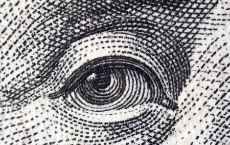 Human eye. Fragment of $100 banknotes.の写真素材