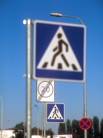 Traffic signs against a clear blue sky.の写真素材
