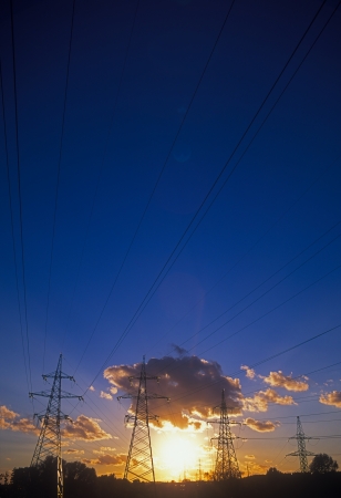 Electric power lines against a beautiful sunset.の写真素材