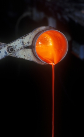 Melting gold in a crucible to manufacture gold grains.の写真素材