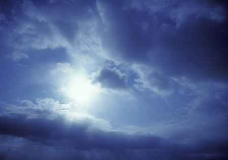 A sky panorama with the sun, blue sky, and cloudsの写真素材