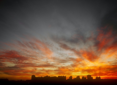 Ominous glowing sunset over a dark landscape の写真素材
