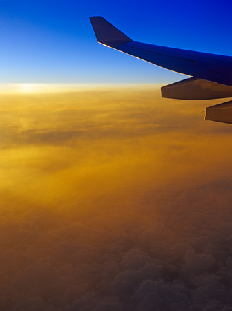 View of sunset over a clouds from the aircraft window.の写真素材