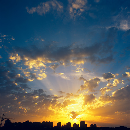 Beautiful sunset over a dark cityscape.の写真素材