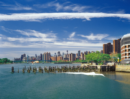 Old pier pylons near East Harlem bay. View from the Harlem River.の写真素材