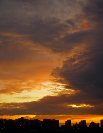 Beautiful sunset over a dark cityscape.の写真素材
