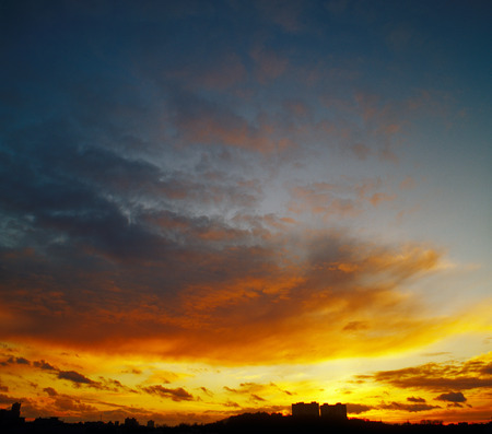 Beautiful sunset over a dark cityscape.の写真素材
