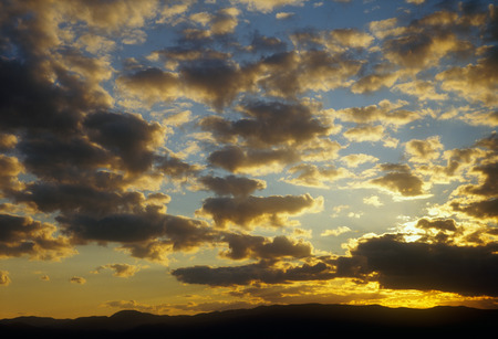 Beautiful sunset over a dark mountain landscape.の写真素材