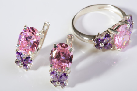 Beautiful gold ring and earrings with gemstones on a white background.の写真素材