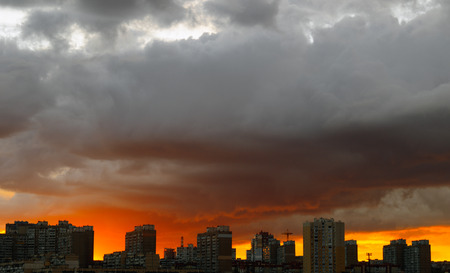 Beautiful sunset over a dark city.の写真素材