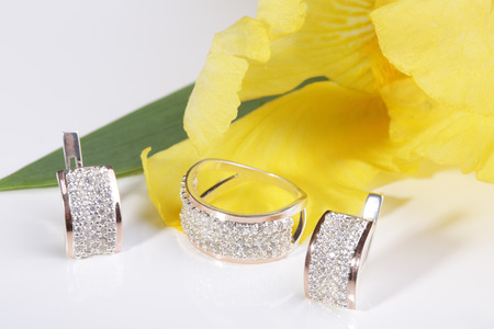Beautiful gold ring and earrings on a yellow flower.の写真素材
