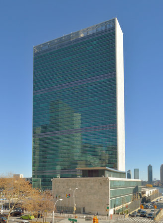 UN Headquarters Building against a clear blue sky.