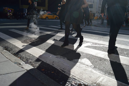 People walking to the crosswalk in Manhattan.