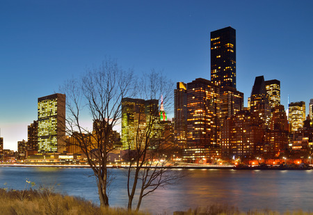 A night view of the New York City skyline from Roosevelt Island.の写真素材