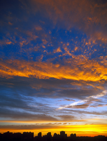 Beautiful sunset over a dark cityscape.の写真素材