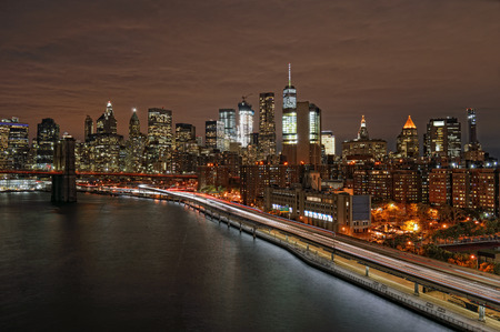 View of Lower Manhattan with Brooklyn Bridge and FDR Drive at night.の写真素材